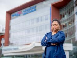 Nursing student standing in front of St. Barnabas Medical Center.