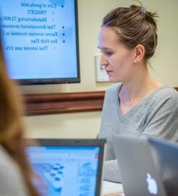 School of Business student working on laptop